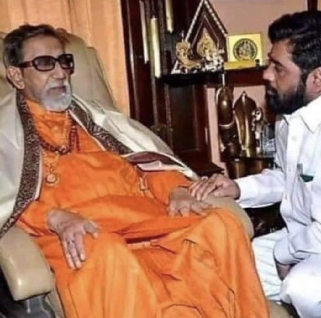 Balasaheb Thackeray in saffron attire with Eknath Shinde sitting beside him in white, 1990s