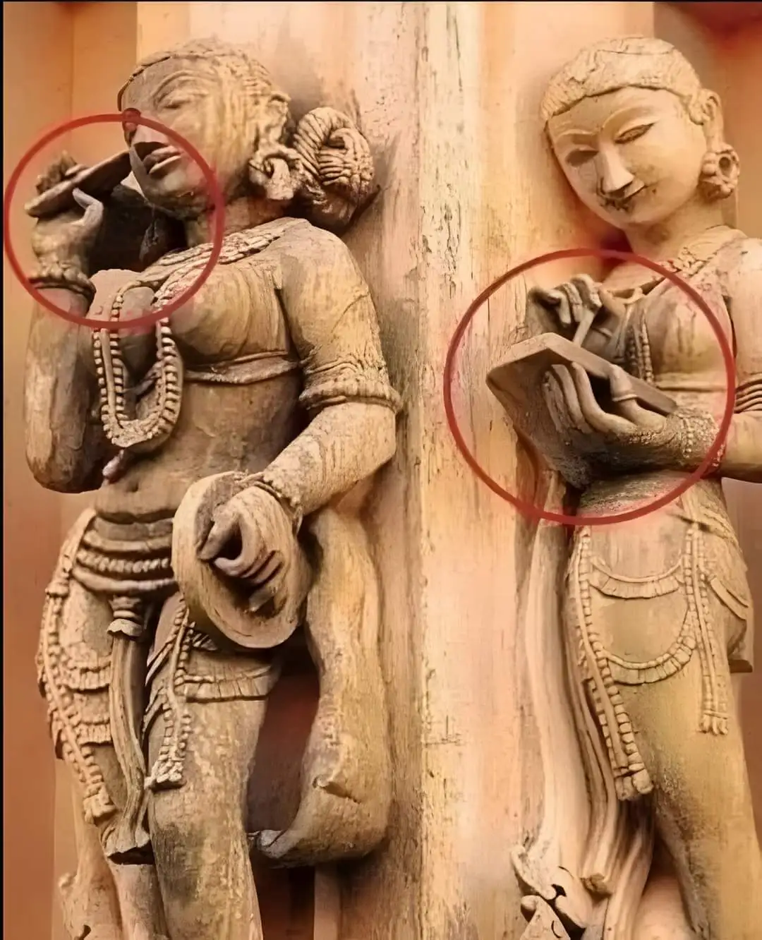 Ancient Indian temple carving depicting figures with objects resembling modern technology.